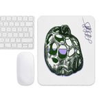 Mouse pad with a unique design on a desk setup with a keyboard and mouse.