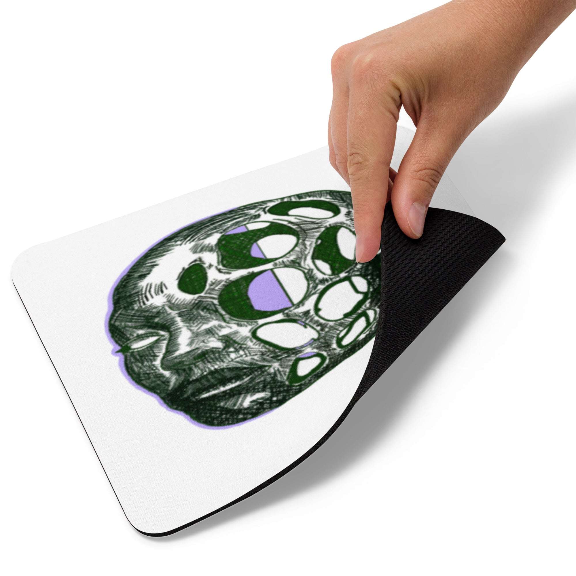 Hand holding a black and white abstract design on a white surface