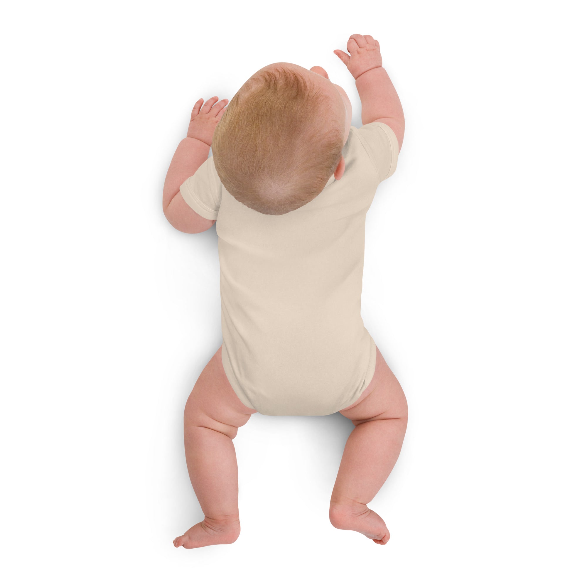 Baby in a white onesie standing on a white background