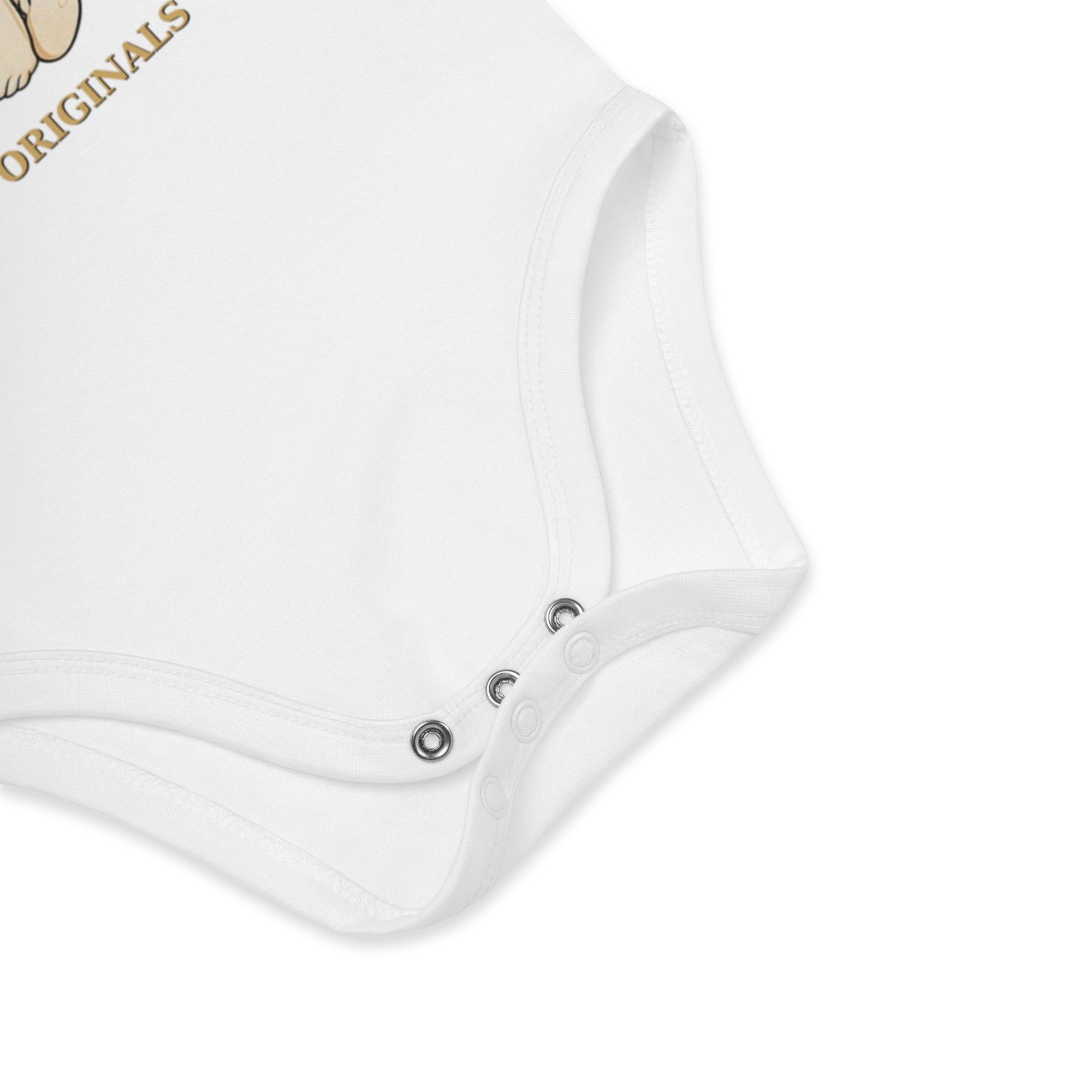 Close-up of a white baby romper with buttons on a light gray background