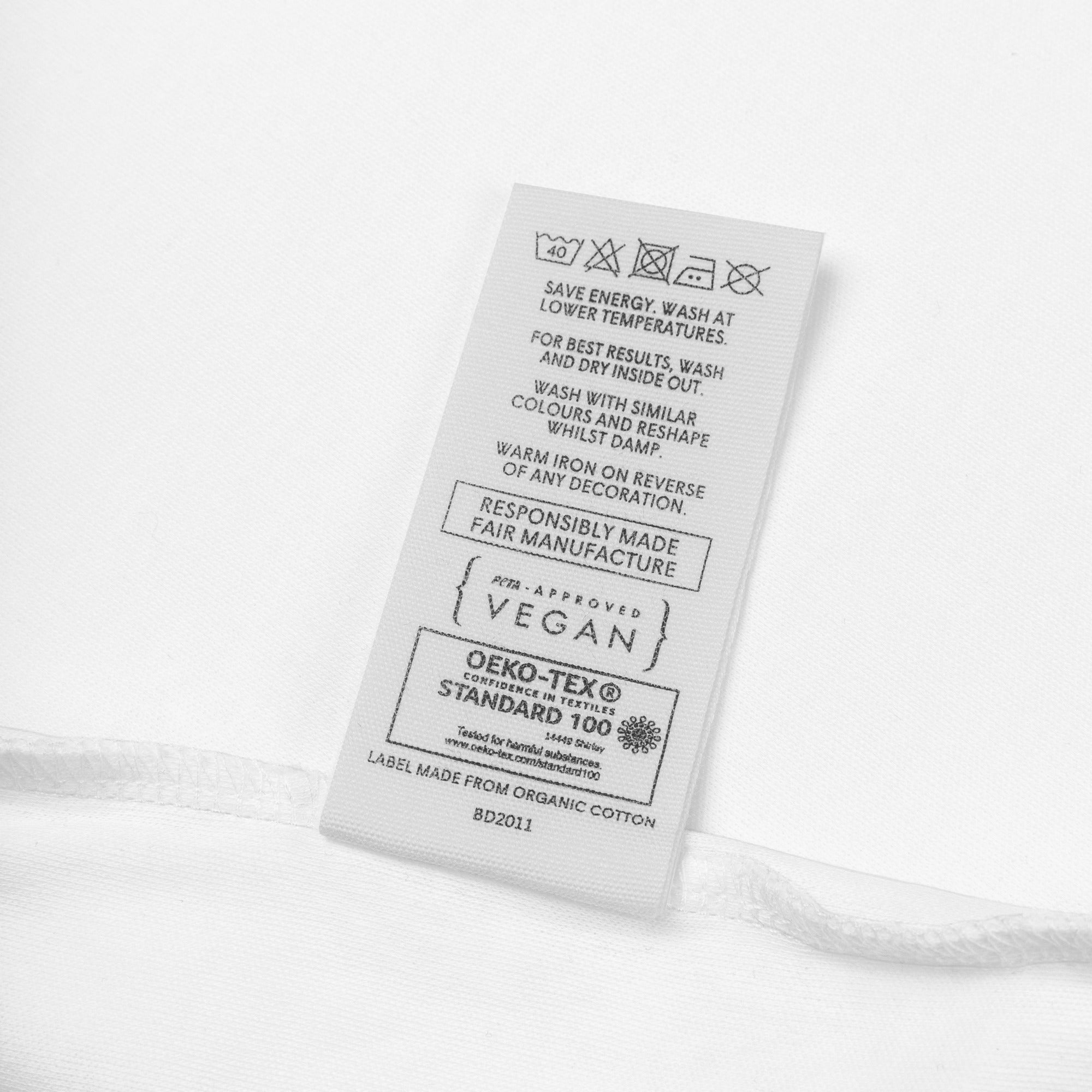 Clothing label with text and logos on a white background