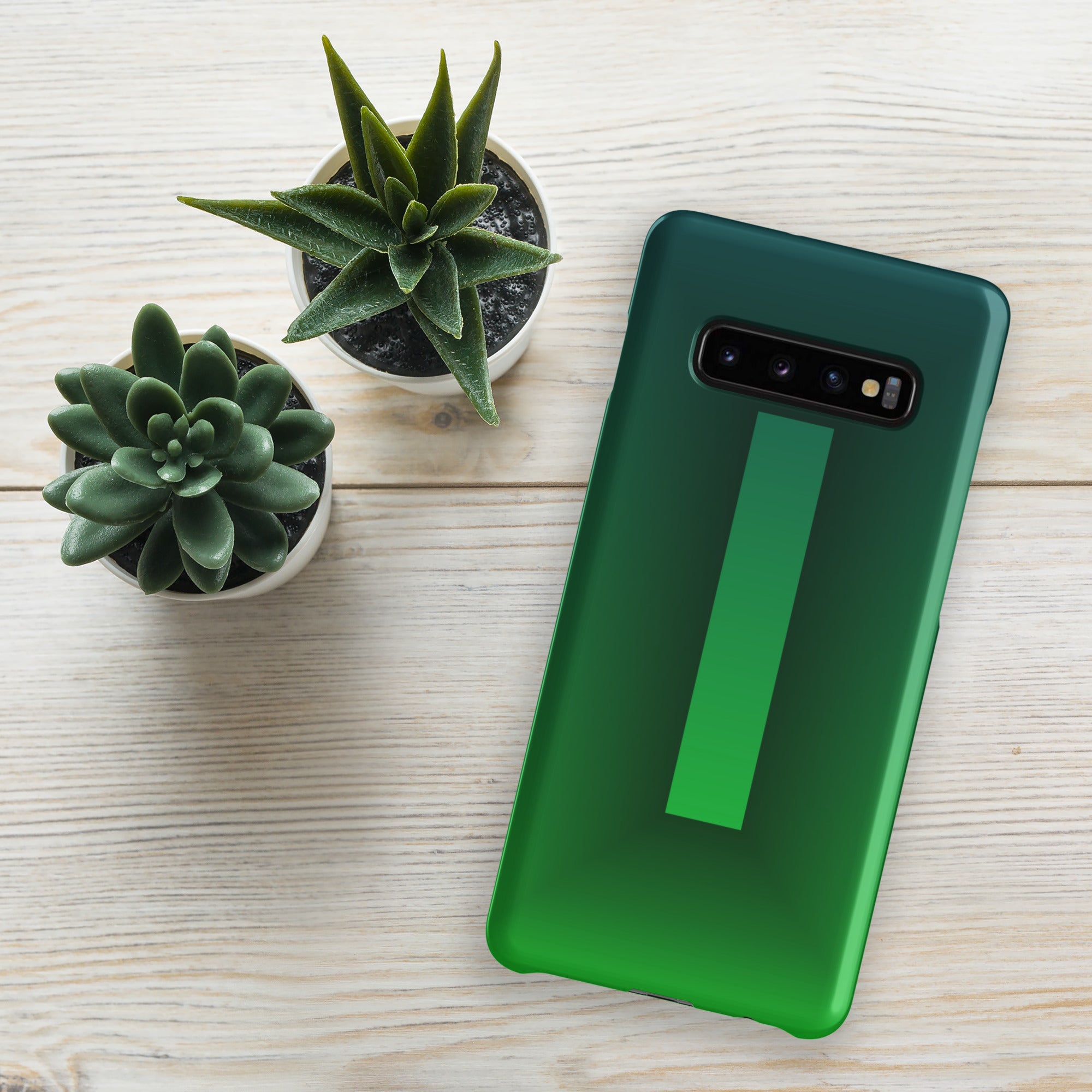 Green phone case on a wooden surface with small potted plants