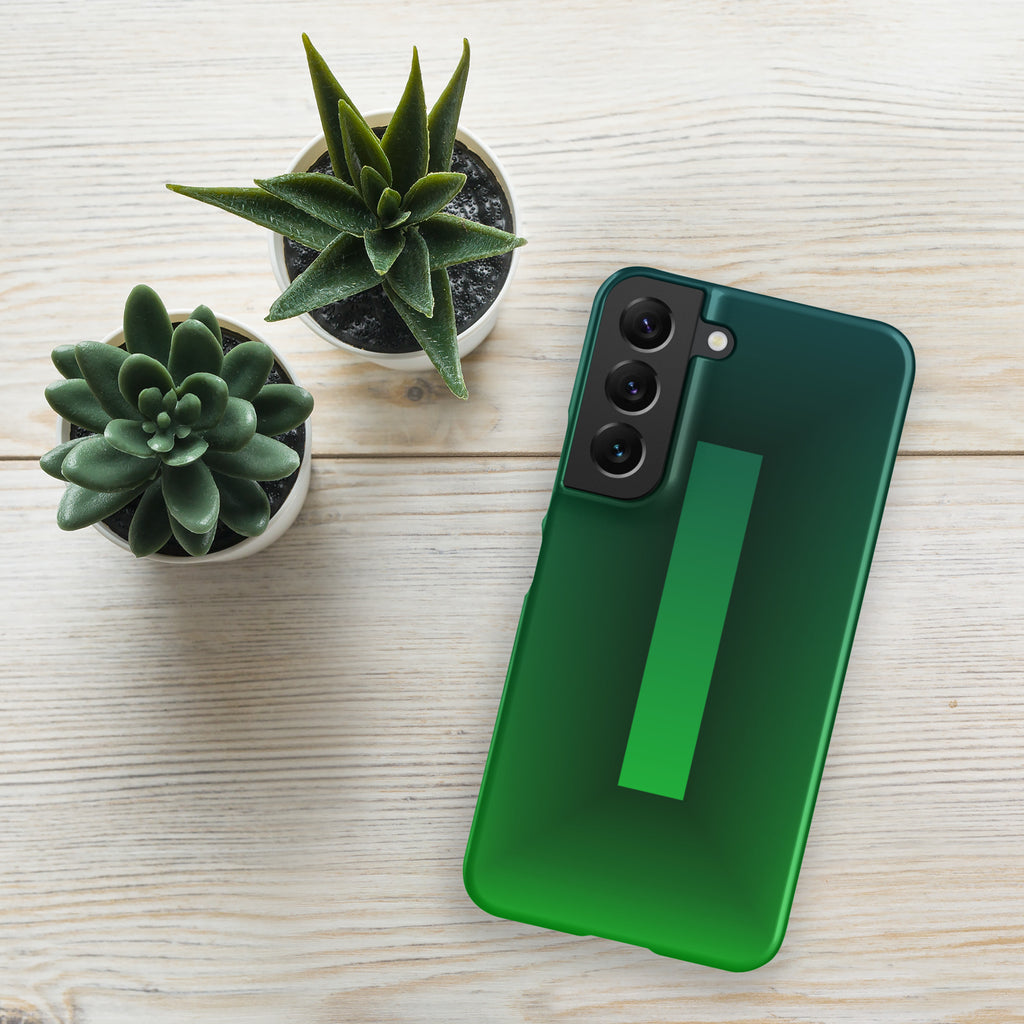 Green phone case on a wooden surface with two small potted plants.