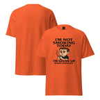 Orange t-shirt with graphic and text 'I'm Not Smoking Today, I'm Givin' Up' on a white background