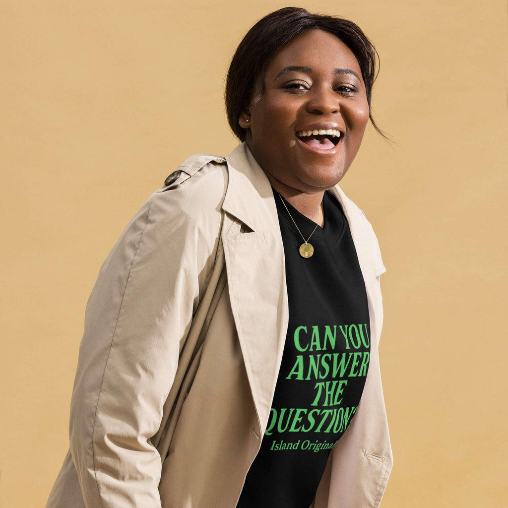 Person wearing a beige trench coat over a black t-shirt with green text on a beige background