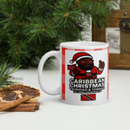 White mug with a festive design featuring a character in a Santa hat and Trinidad and Tobago flag, placed on a surface with Christmas decorations.
